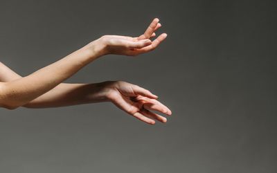 Close-up of a person's hands in a controlled position.